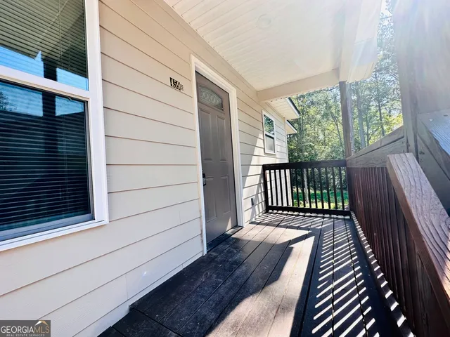 a view of balcony with wooden floor and fence