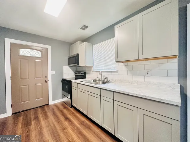 a kitchen with a stove and a microwave