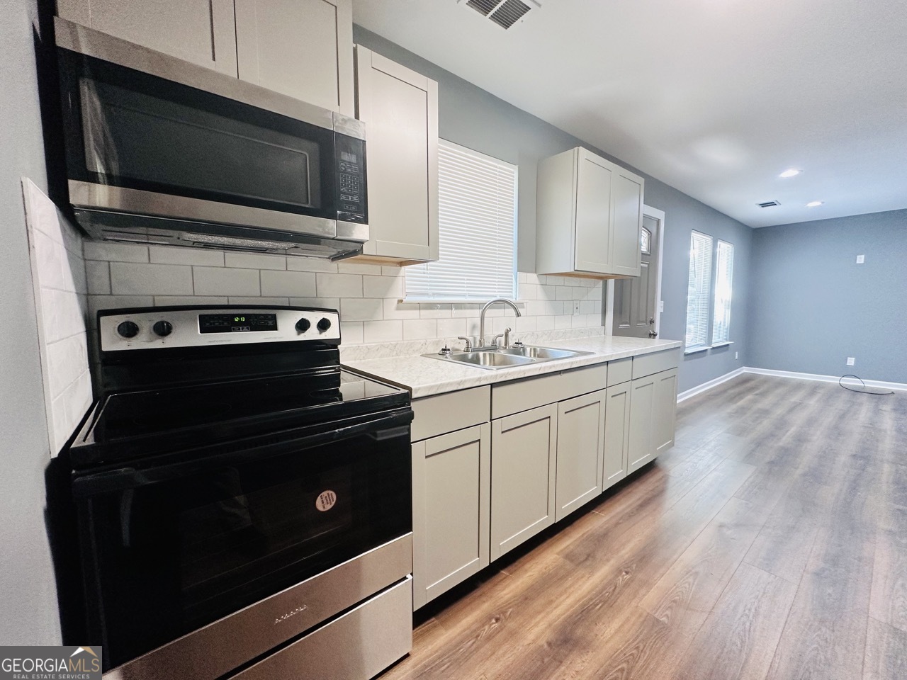 459 Merrywood Drive, Unit B LaGrange, GA 30241 - Photo 8 of 15 a kitchen with a stove and a microwave