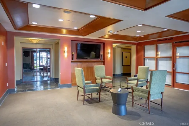 a view of a patio with a table and chairs under an umbrella