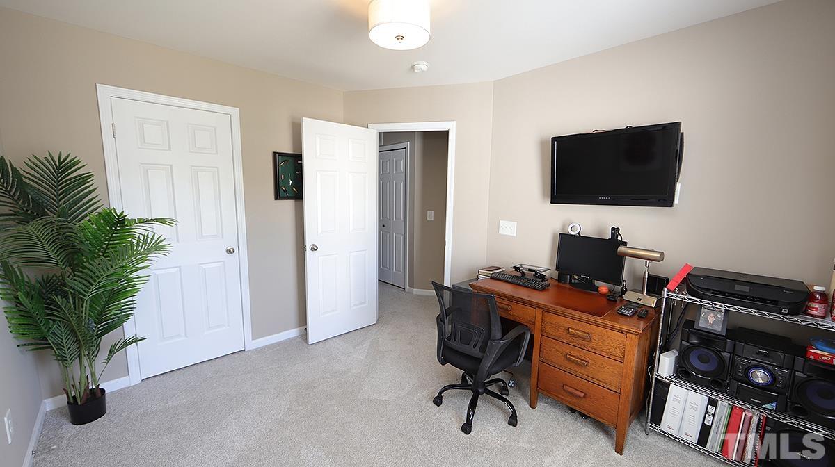 7020 Racine Way Raleigh, NC 27690 - Photo 18 of 26 a view of a workspace with furniture and a potted plant