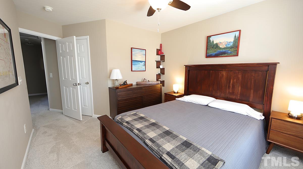 7020 Racine Way Raleigh, NC 27690 - Photo 21 of 26 a bedroom with a bed and a dresser