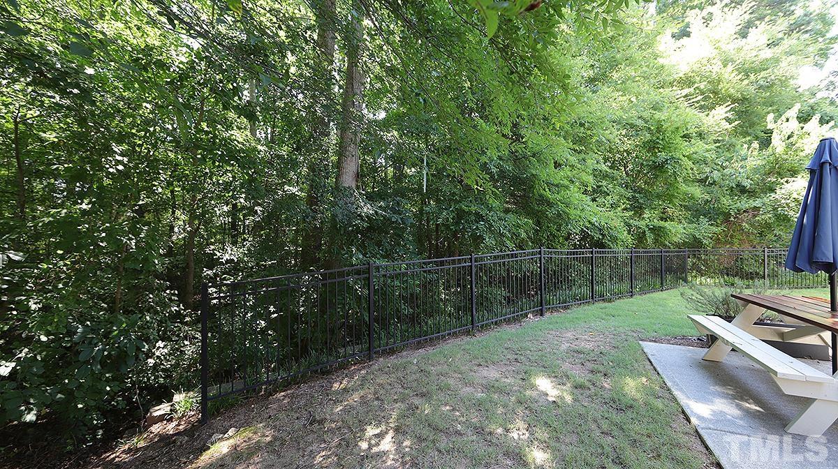 7020 Racine Way Raleigh, NC 27690 - Photo 23 of 26 a view of a backyard with a wooden fence