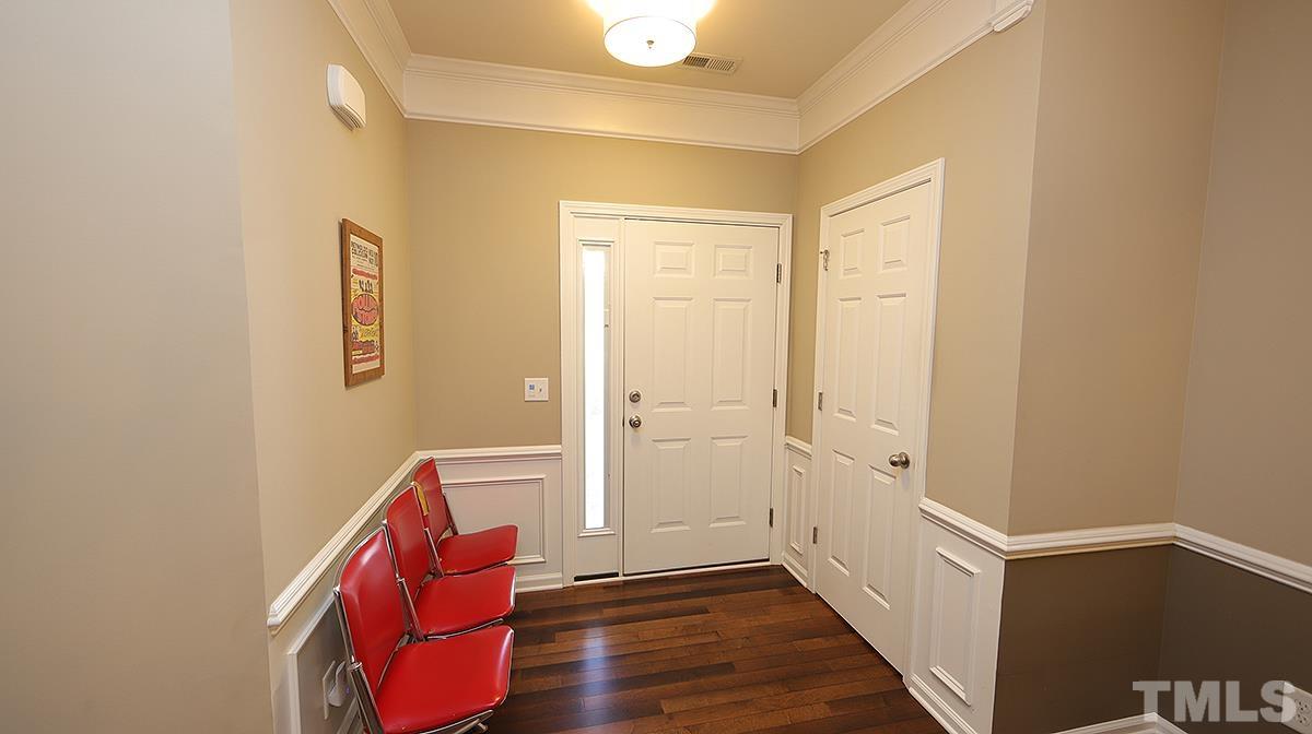 7020 Racine Way Raleigh, NC 27690 - Photo 4 of 26 a view of a hallway with wooden floor and closet