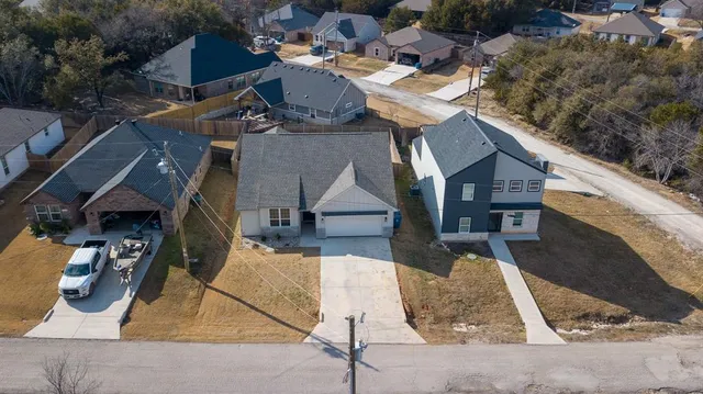 an aerial view of a house with backyard