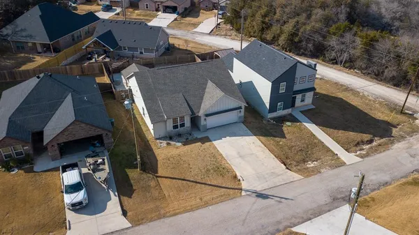 an aerial view of residential houses with outdoor space