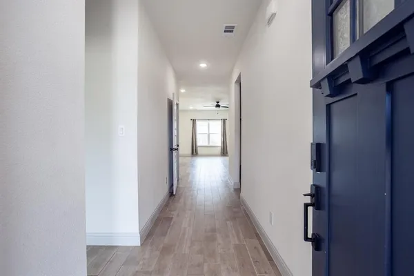 a view of hallway with wooden floor