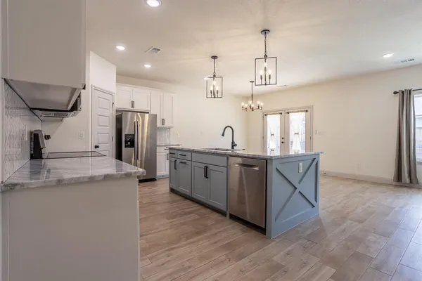 a kitchen with stainless steel appliances granite countertop a sink and stove