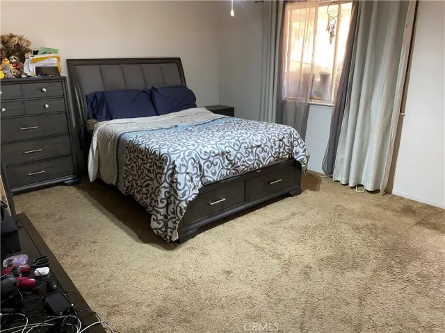 a bedroom with a bed and window