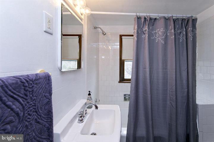 1610 South Loudoun Street Winchester, VA 22601 - Photo 24 of 38 a bath room with a sink and a mirror