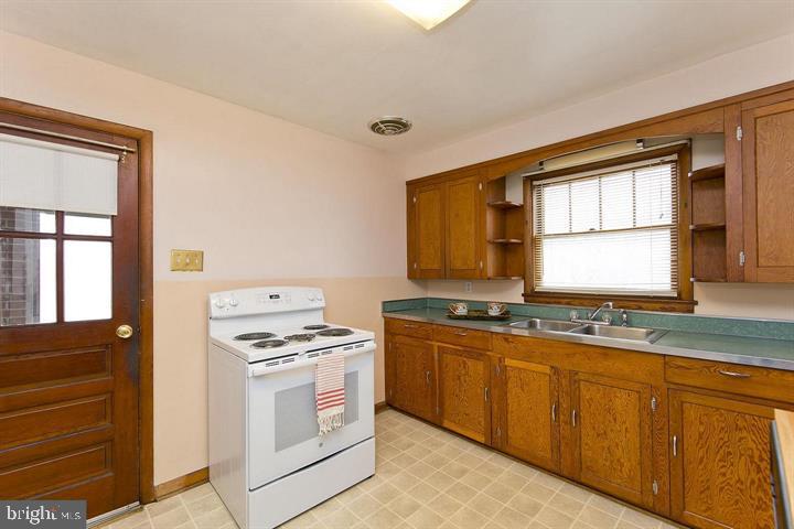 1610 South Loudoun Street Winchester, VA 22601 - Photo 7 of 38 a kitchen with granite countertop cabinets stainless steel appliances and a window
