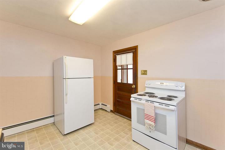1610 South Loudoun Street Winchester, VA 22601 - Photo 10 of 38 a kitchen with a stove and a refrigerator