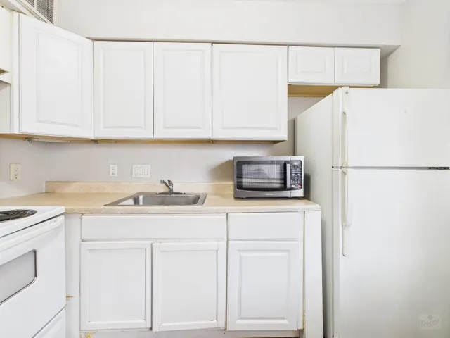 a kitchen with stainless steel appliances granite countertop a sink and a stove