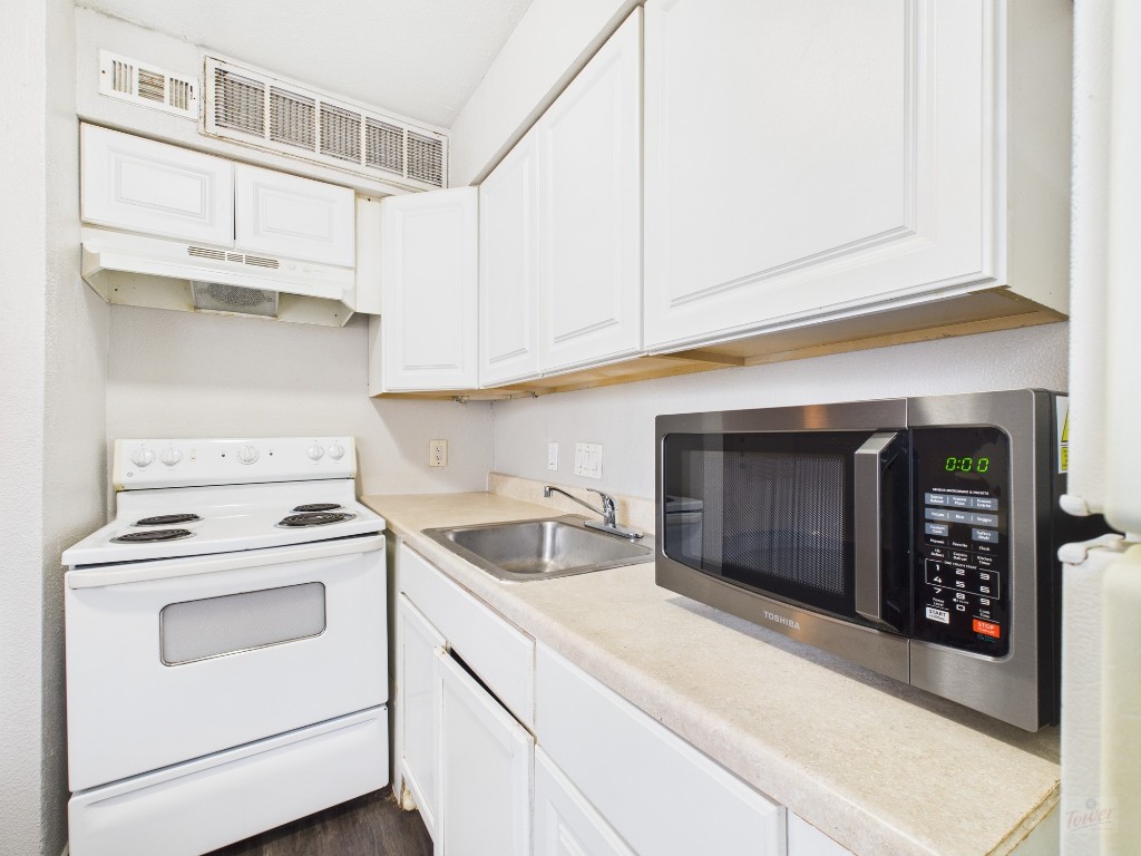 1840 Burton Drive, Unit 141 Austin, TX 78741 - Photo 12 of 24 a kitchen with stainless steel appliances granite countertop a sink and a stove