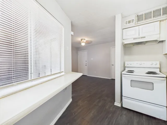 a view of a kitchen with a stove cabinets