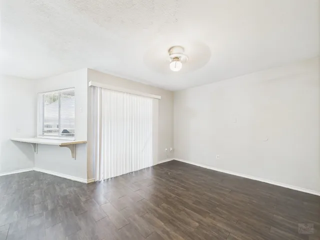 a view of a room with wooden floor