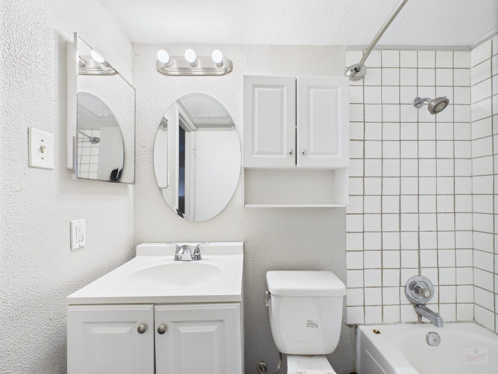 1840 Burton Drive, Unit 141 Austin, TX 78741 - Photo 23 of 24 a bathroom with a toilet sink and mirror