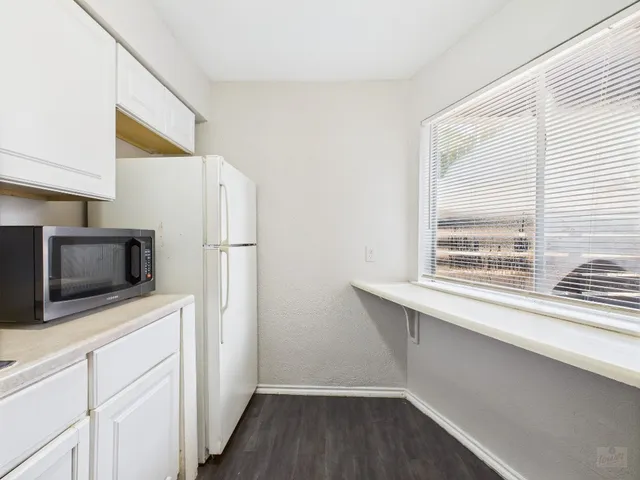 a kitchen with stainless steel appliances a microwave a sink and cabinets
