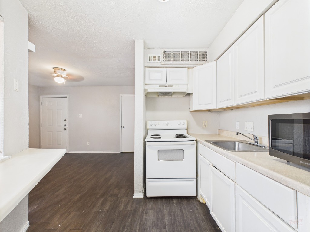 1840 Burton Drive, Unit 141 Austin, TX 78741 - Photo 6 of 24 a kitchen with a sink a stove and cabinets