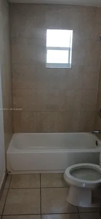 a bathroom with a toilet and a bathtub