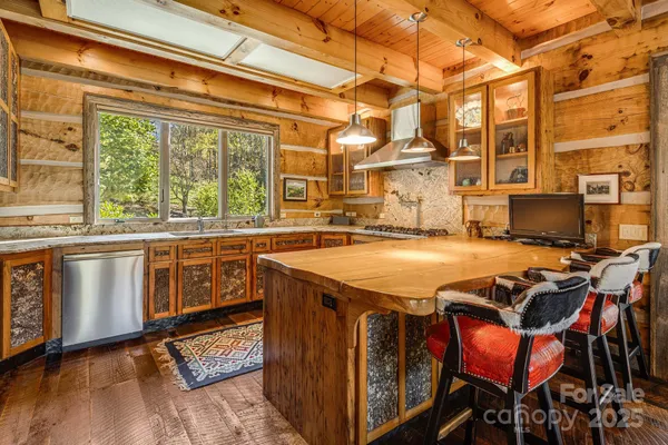 a open kitchen with stainless steel appliances granite countertop a stove and cabinets