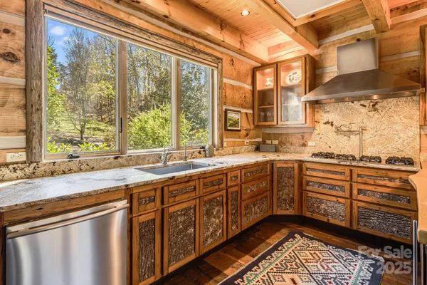 a kitchen with stainless steel appliances a sink and cabinets