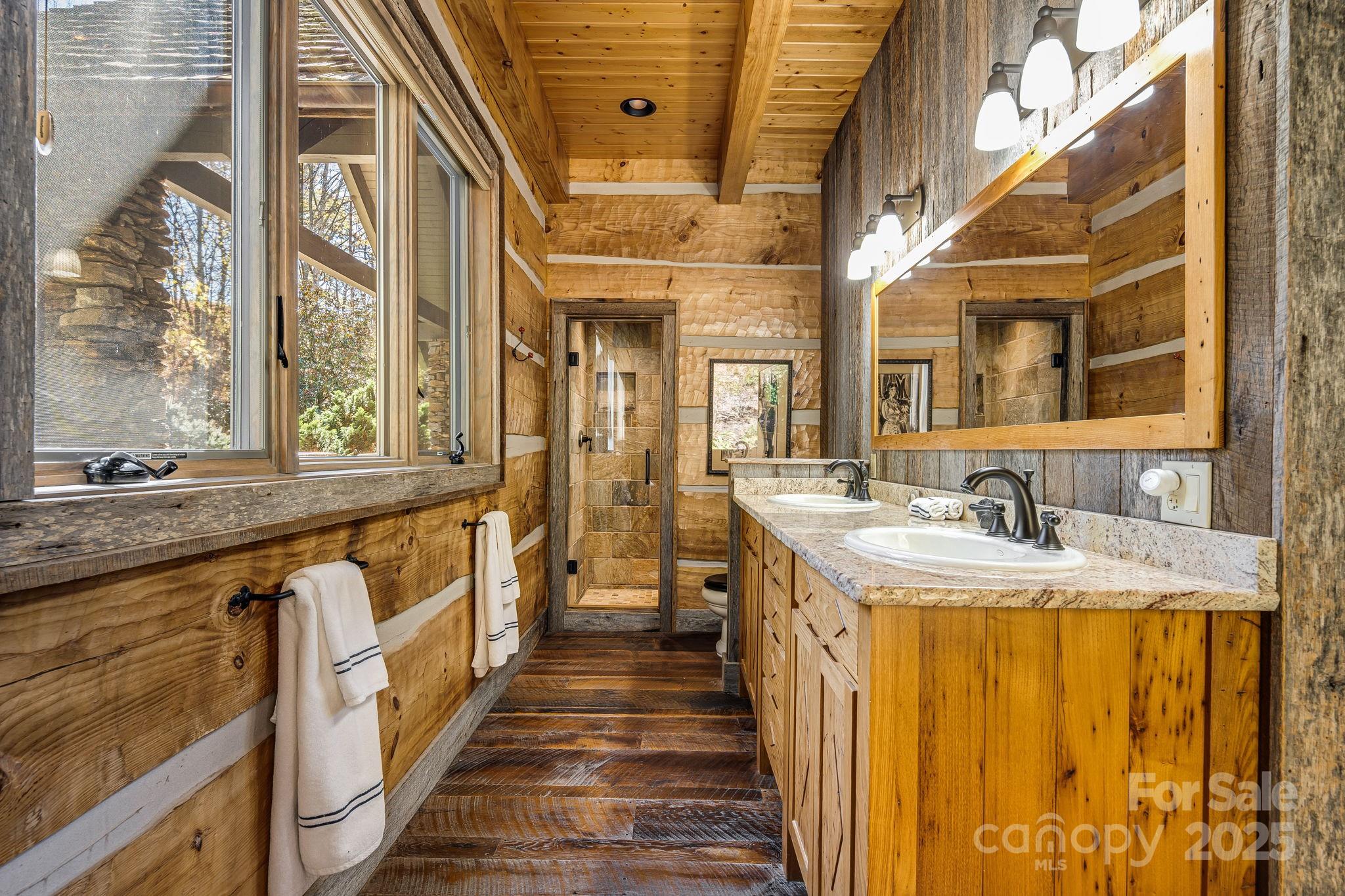 99 Thistle Ridge Canton, NC 28716 - Photo 20 of 48 a bathroom with a granite countertop sink and a large mirror