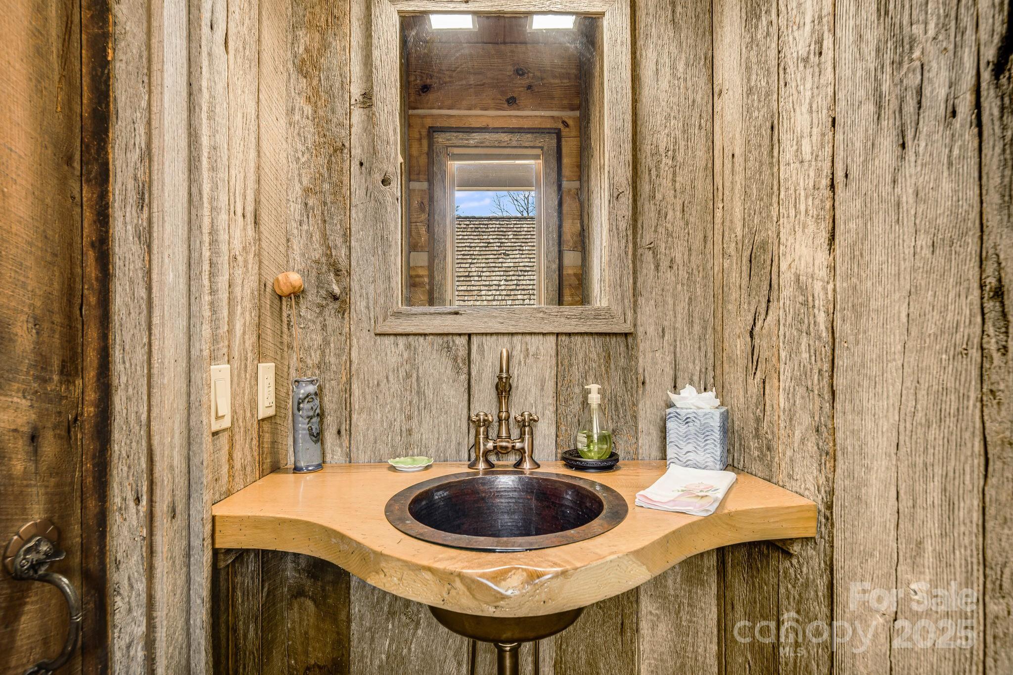 99 Thistle Ridge Canton, NC 28716 - Photo 22 of 48 a bathroom with a sink and a mirror