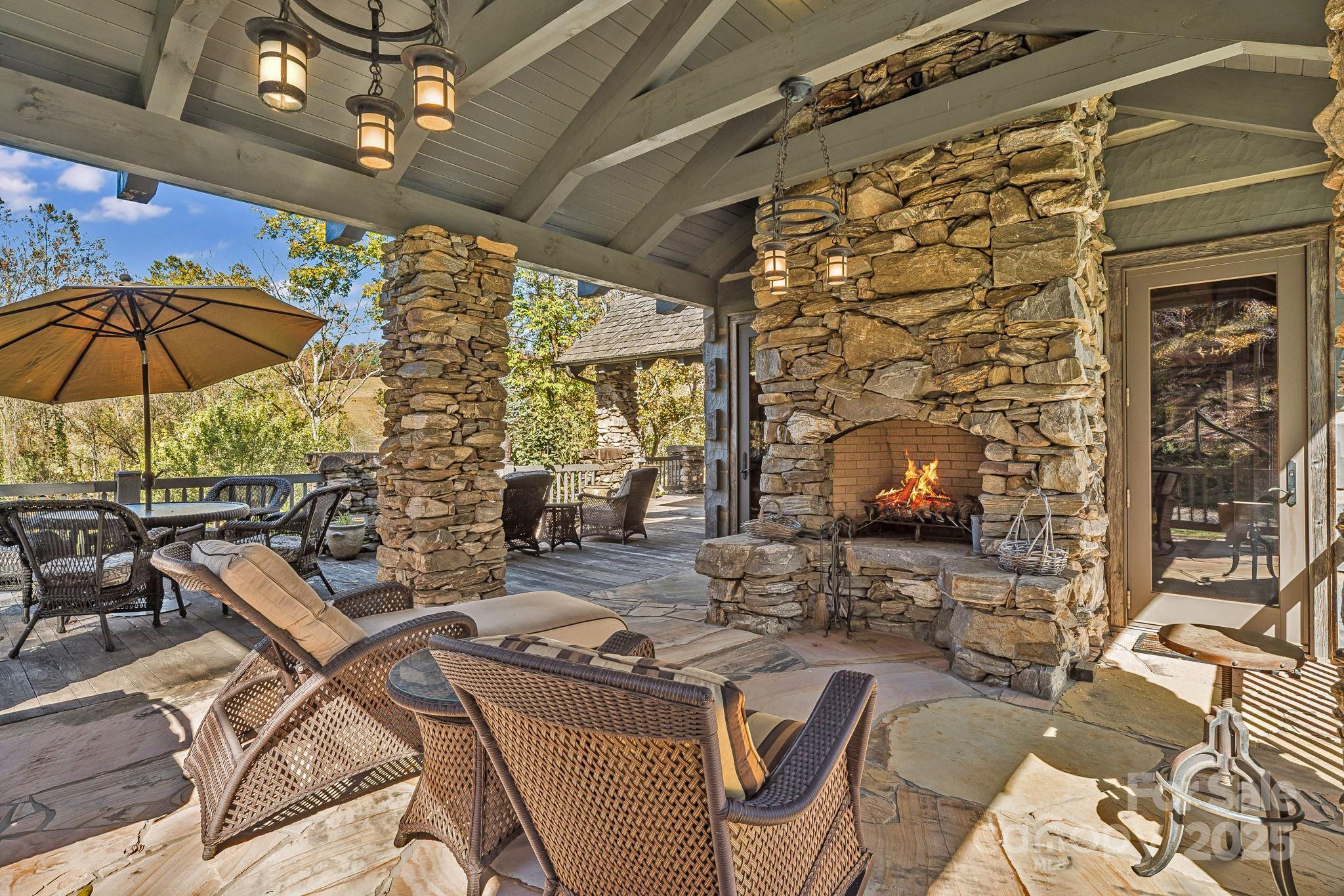 99 Thistle Ridge Canton, NC 28716 - Photo 32 of 48 a outdoor space with patio the couches and a fireplace with the potted plants