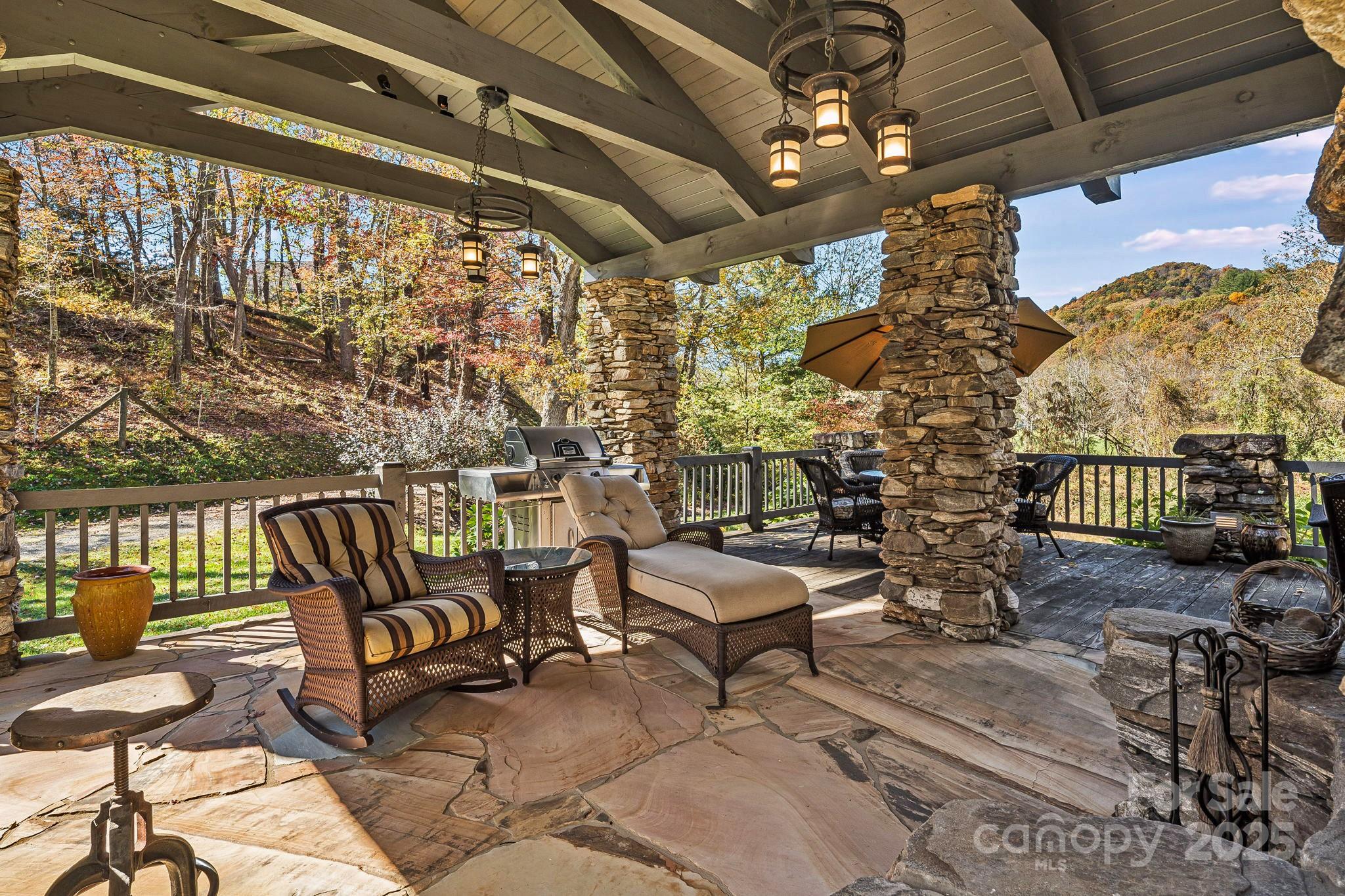 99 Thistle Ridge Canton, NC 28716 - Photo 34 of 48 a roof deck with couches and wooden floor