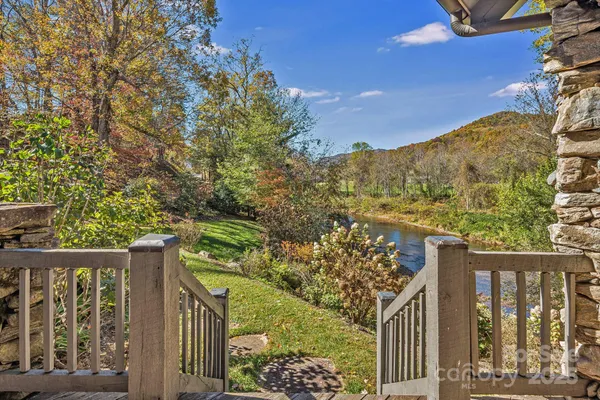 a view of a pathway of a house with a tree in the background