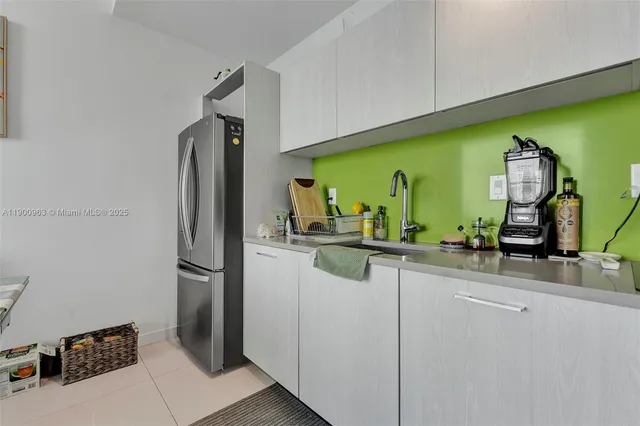 a kitchen with a refrigerator and a sink