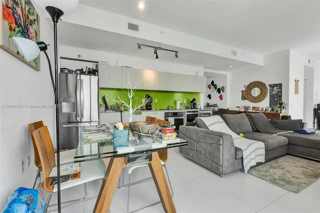 a living room with fireplace furniture and a large window