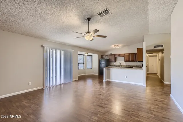 a view of kitchen with refrigerator and window