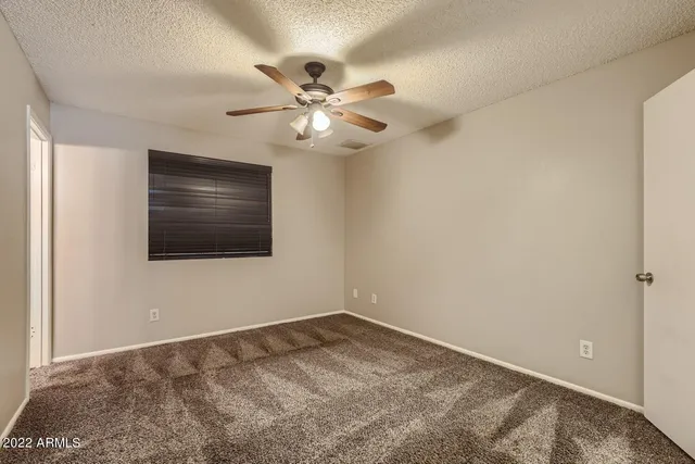 a view of an empty room with a fan
