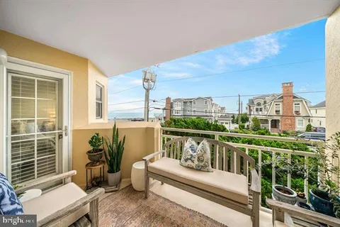 a bedroom with a bed and a lamp on a dresser