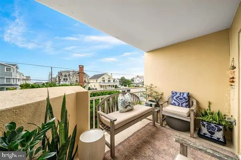 a view of a kitchen with furniture a rug and wooden floor