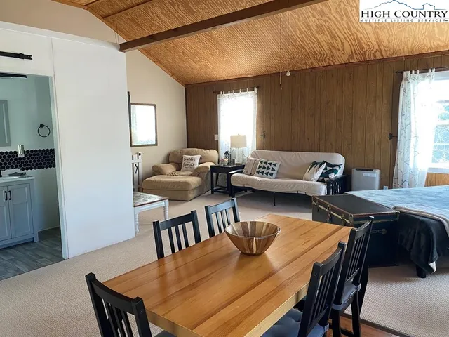 a view of a dining room with furniture and window