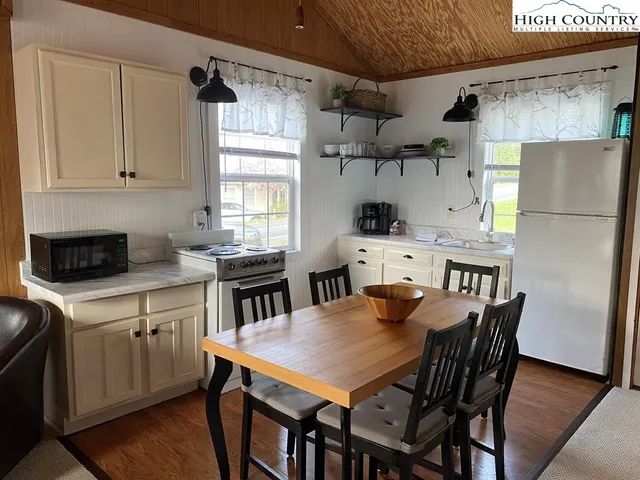 a kitchen with a dining table and chairs