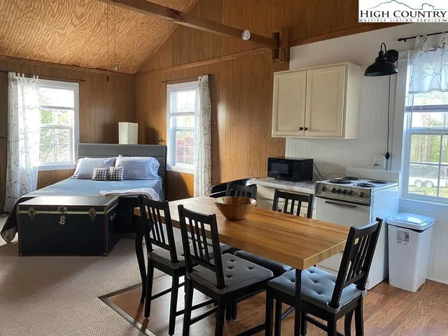 a dining room with a wooden table and chairs