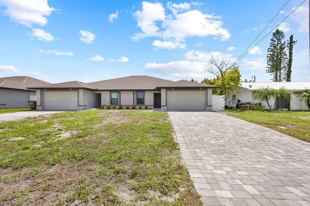 3429 Southwest 8th Place Cape Coral, FL 33914 - Photo 1 of 19 a front view of a house with garden