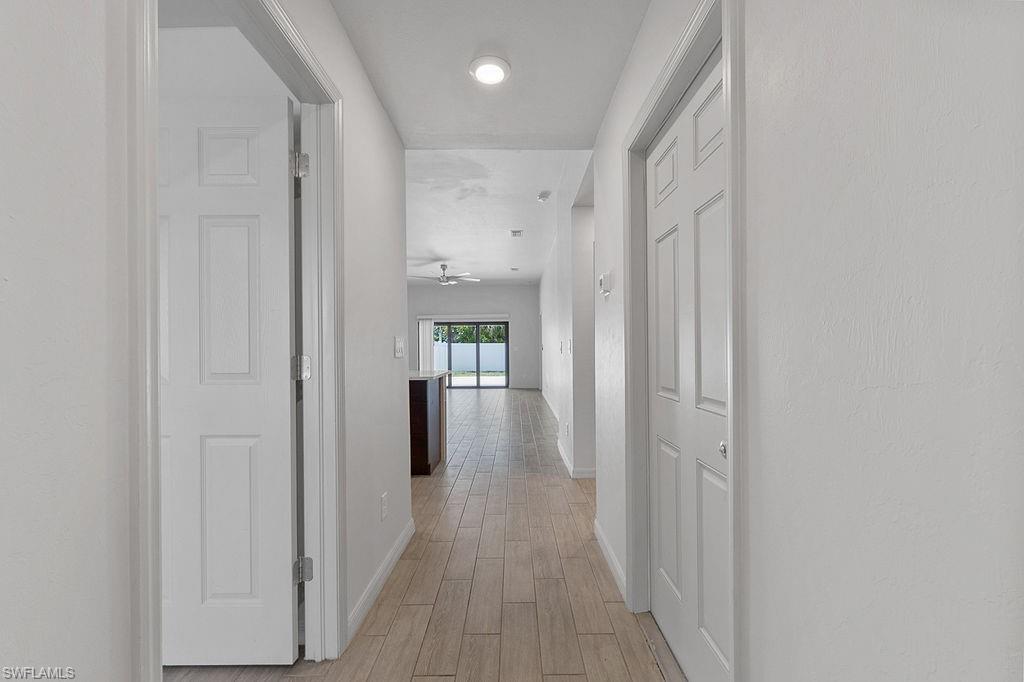 3429 Southwest 8th Place Cape Coral, FL 33914 - Photo 3 of 19 a view of a hallway with wooden floor