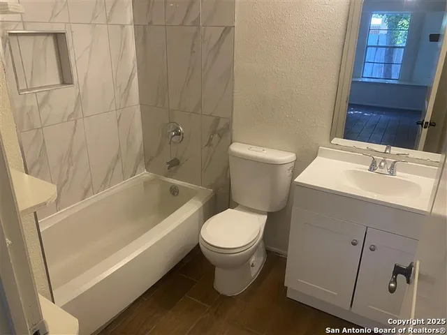 a bathroom with a toilet and a bathtub