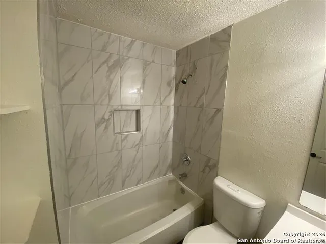 an empty room with fan and fan