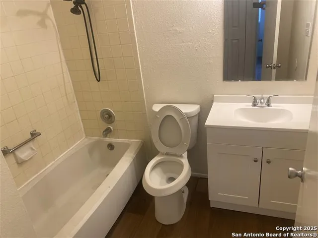 a view of a backyard with a tree