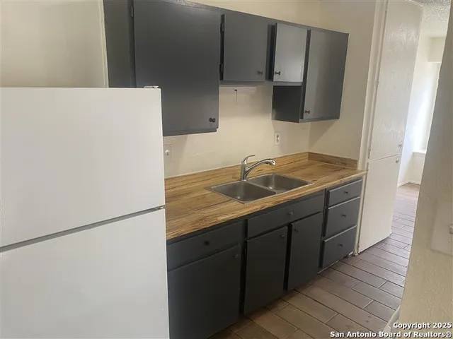a kitchen with a sink stove and refrigerator