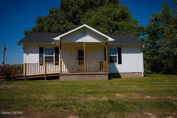a view of a house with a yard and fence