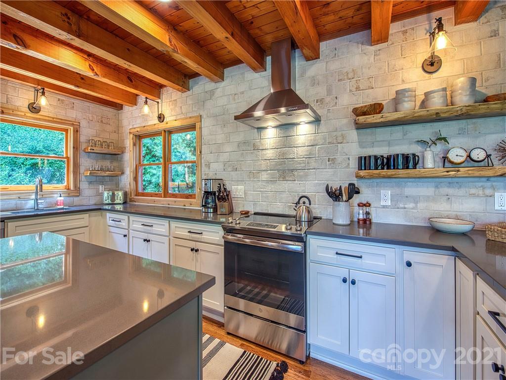 1933 Laurel Ridge North Maggie Valley, NC 28751 - Photo 12 of 44 a kitchen with stainless steel appliances granite countertop a sink a stove and cabinets