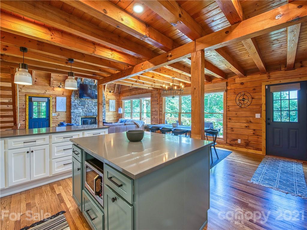 1933 Laurel Ridge North Maggie Valley, NC 28751 - Photo 16 of 44 a kitchen with stainless steel appliances granite countertop a sink and wooden floors