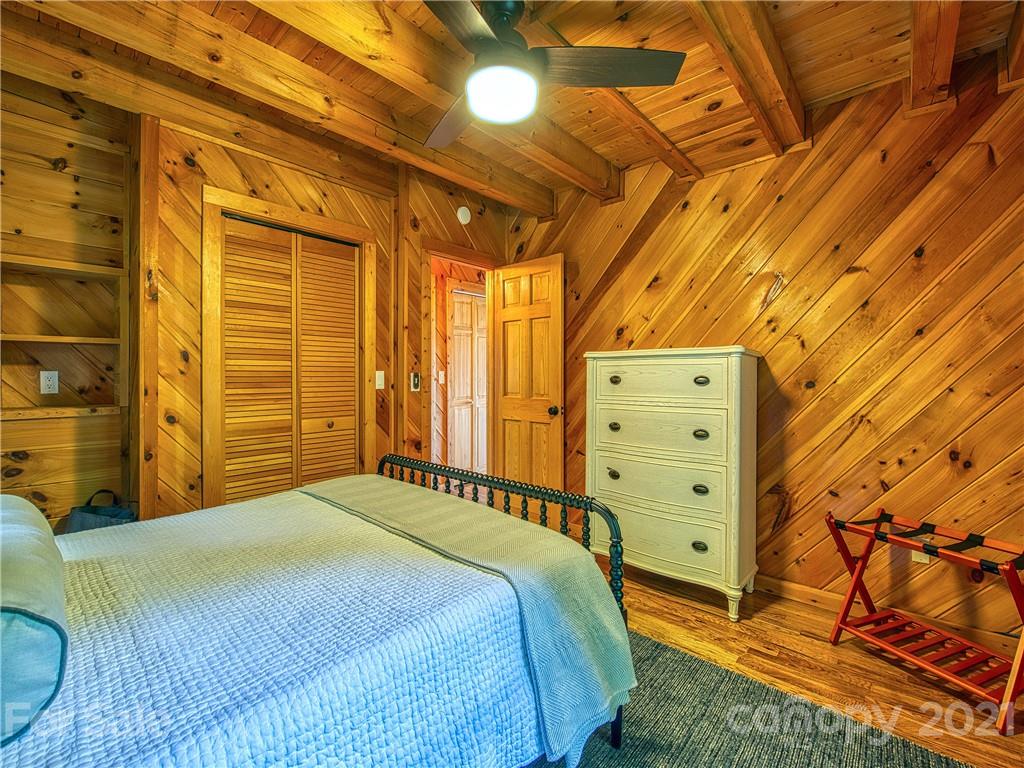 1933 Laurel Ridge North Maggie Valley, NC 28751 - Photo 23 of 44 a bedroom with a bed and a dresser